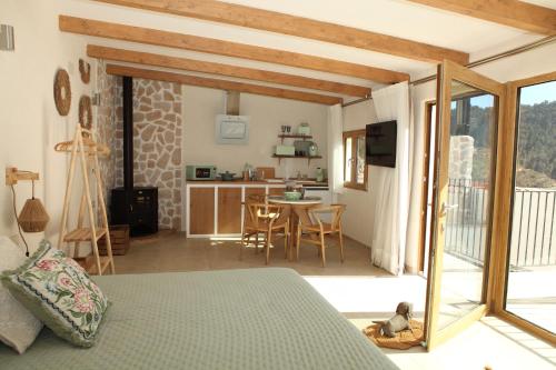 a bedroom with a bed and a kitchen with a table at Paraiso Suit Casas Lacambra in Tolosa