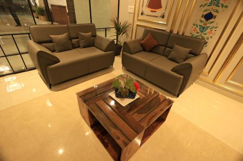 a living room with two couches and a coffee table at Krishna Resort Pushkar in Pushkar