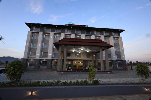 a hotel with a large building in front of it at Krishna Resort Pushkar in Pushkar