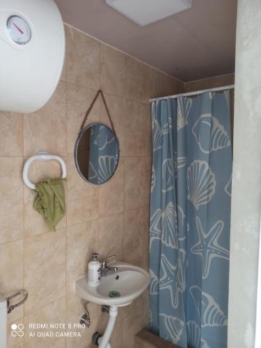 a bathroom with a sink and a shower at Bay View Escape in Igalo