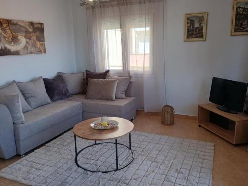 a living room with a couch and a coffee table at Αλόη in Kastoria