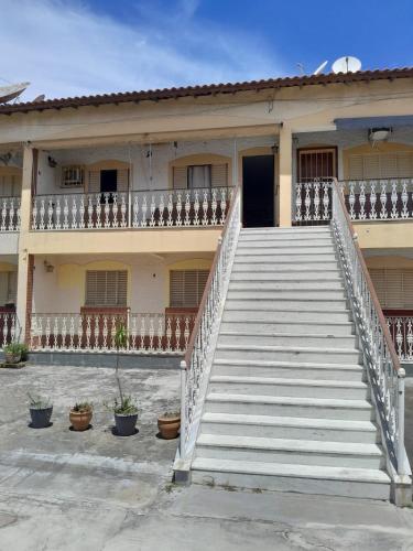 a building with stairs in front of it with a door at Amplo APT próximo a lagoa/centro in Araruama
