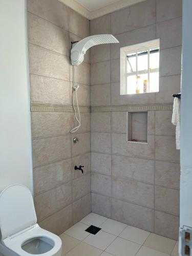 a bathroom with a shower with a toilet at Kijani Holiday Home in Nanyuki