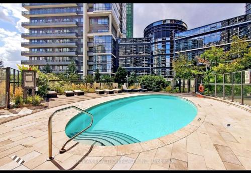 a swimming pool in a city with tall buildings at Condo at Yonge-Sheppard Station, North York in Toronto