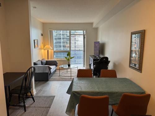a living room with a table and a couch at Condo at Yonge-Sheppard Station, North York in Toronto