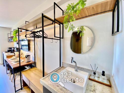 a bathroom with a sink and a mirror at Beach Haus By 123Quarto hospedagem in Tambaú