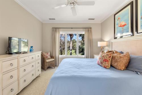 una camera con letto blu e TV di 115 Bufflehead Drive by Akers Ellis Rentals a Kiawah Island