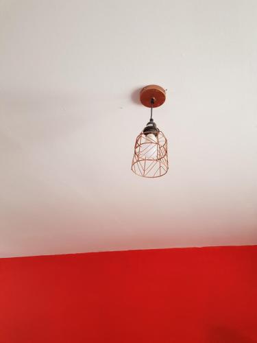 aendant light hanging from the ceiling of a room at Maun self-catering unit in Maun