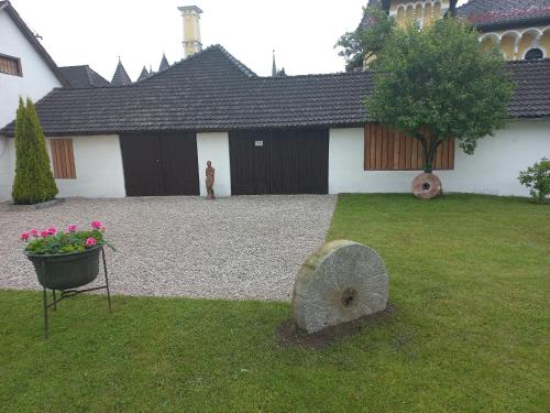a person standing in the yard of a house at Apartment Kogler in Globasnitz