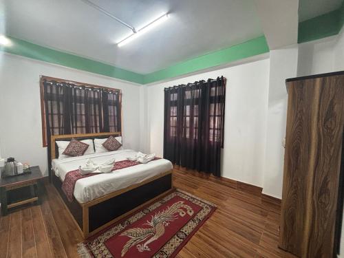 a bedroom with a bed and a rug on the floor at Lachung Comfotel by Rare Himalayas in Lachung