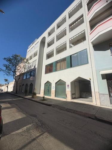 a white building on the side of a street at AlbaChiara in Alghero