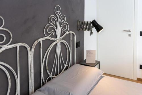 a bed with a metal headboard in a room at Il Treno dei Sogni - Bed & Relais in Conselve