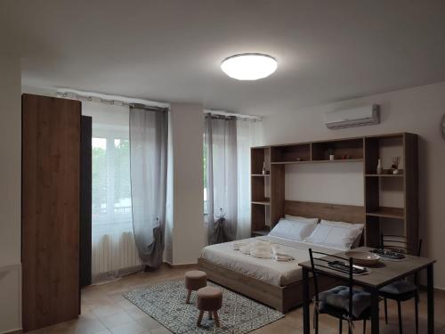 a bedroom with a bed and a table and a desk at Vera Alloggio Alessandria nr2 in Alessandria