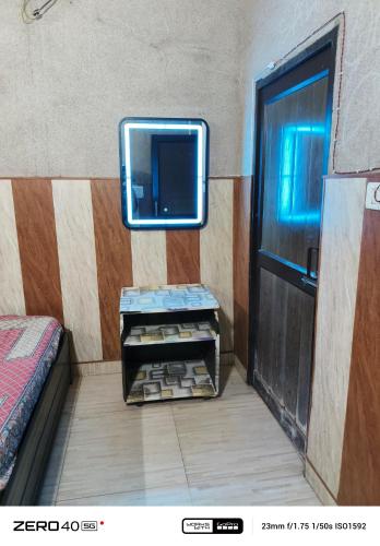 a room with a bed and a mirror on the wall at SIDHU GUEST HOUES -400 walking distance From golden Temple in Amritsar