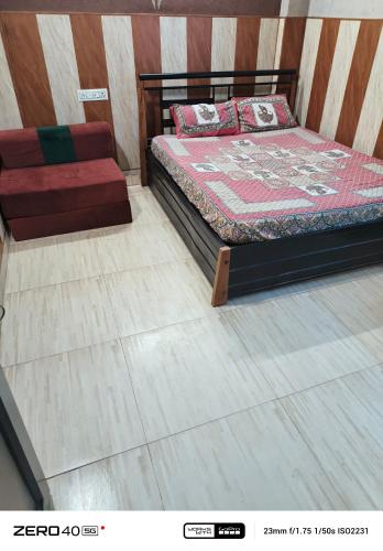 a bedroom with a bed and a wooden floor at SIDHU GUEST HOUES -400 walking distance From golden Temple in Amritsar