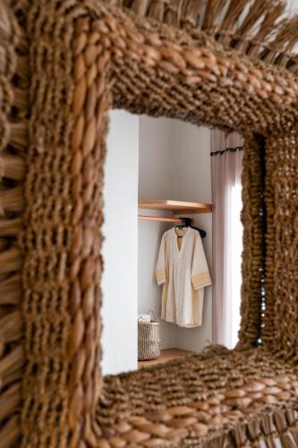 a white shirt hanging on a hanger in a room at Sea & Sun Paros in Naousa
