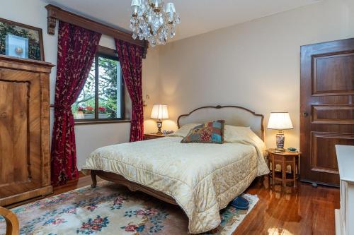 a bedroom with a bed and a chandelier at An eclectic pied a terre in Dionysos in Dhiónisos