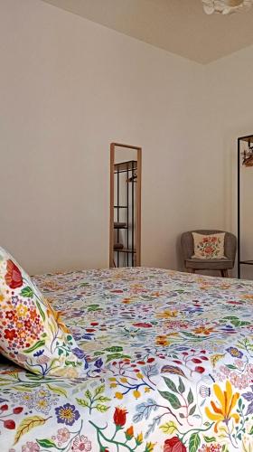 a bedroom with a bed with a colorful bedspread at Sosta a colori in Trapani