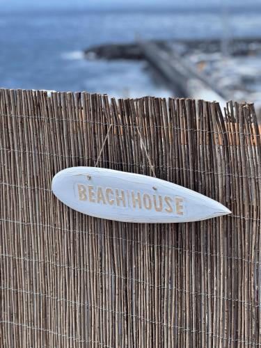 a surfboard sitting on top of a wooden fence at YOSO Tenerife in Acantilado de los Gigantes