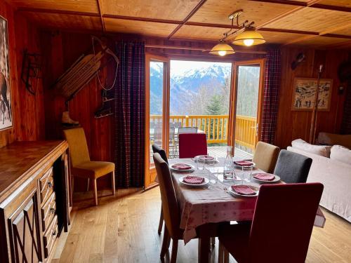 - une table à manger et des chaises dans une chambre avec balcon dans l'établissement Chalet spa bath fireplace ski-in out, à Ax-les-Thermes