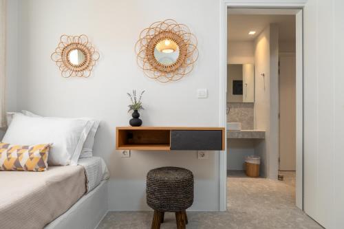 a bedroom with a bed and a mirror and a stool at Sea & Sun Paros in Naousa