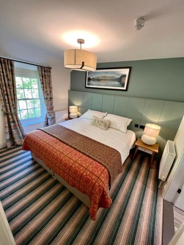 a bedroom with a large bed in a room at Royal Oak Hotel in Rosthwaite