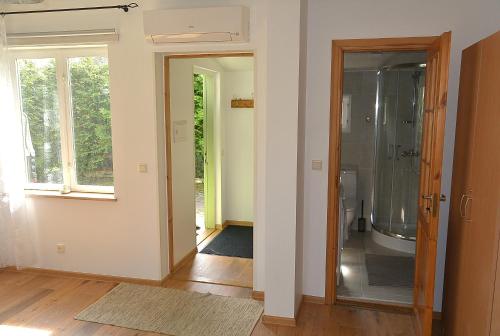 a bathroom with a shower and a glass door at Supeluse 23 Holiday Home in Pärnu