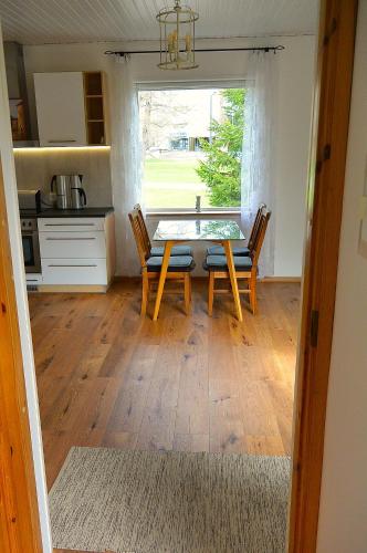 a kitchen and dining room with a table and chairs at Supeluse 23 Holiday Home in Pärnu