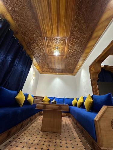 a blue couch with yellow pillows in a room at Dar Salam in Rabat