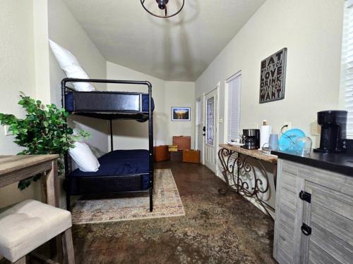 a bedroom with a bunk bed in a room at Fredericksburg Stay W Patio, Fire Pit & Hot Tub in Fredericksburg