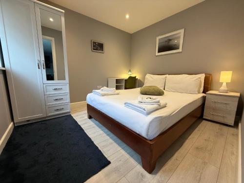 a bedroom with a bed with a dresser and a mirror at Private Holiday Home, Great Location in Brighton & Hove