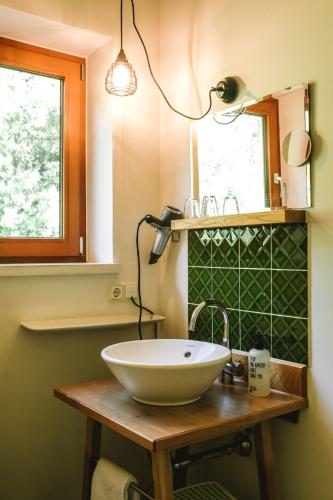 a bathroom with a bowl sink on a wooden table at Der Tannenhof in Reutte