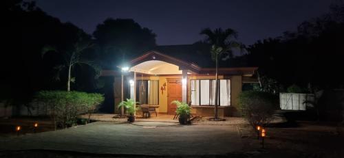 a house with a lit up front yard at night at Casa Mathi in Portegolpe