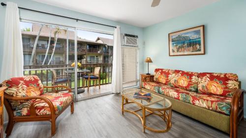 a living room with a couch and a table at Kona Isle B22 in Kailua-Kona