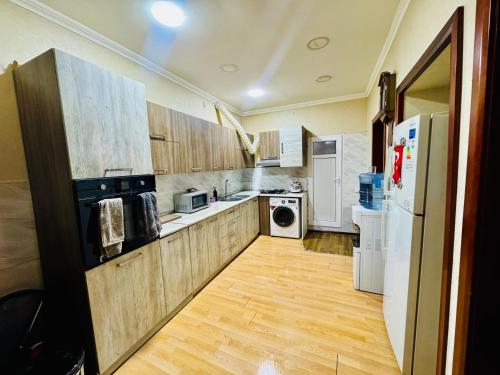 a kitchen with white appliances and wooden cabinets at Central Baku Hostel in Baku