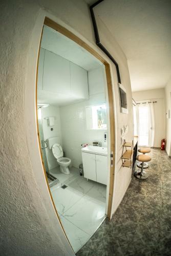 a bathroom with a mirror and a sink and a toilet at Blackeye Hidden cottage in Nea Potidaea