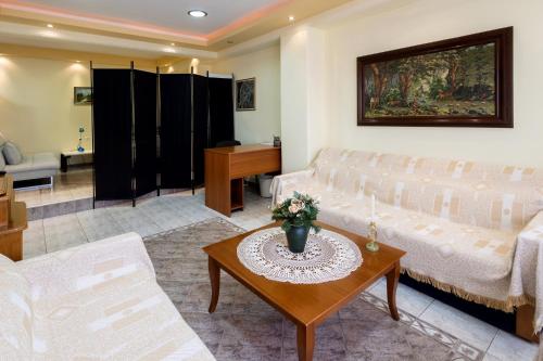 a living room with a couch and a table at Zant house in Tríkala