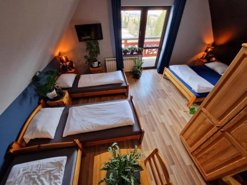 an overhead view of a room with three beds at Pensjonat Harmatówka - Blisko basenów termalnych in Bukowina Tatrzańska