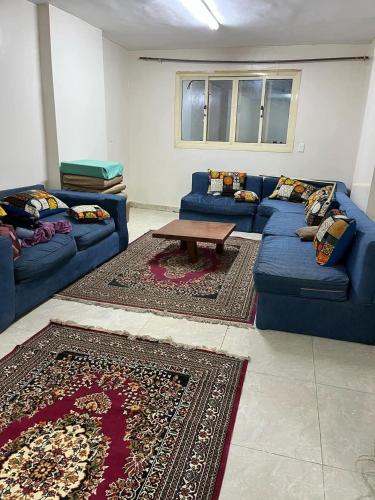 a living room with blue couches and a coffee table at جبال الاردن in Amman