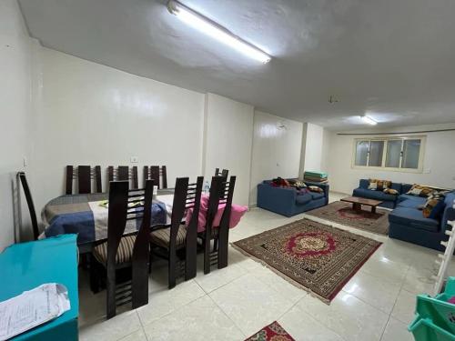 a living room with a table and chairs and a couch at جبال الاردن in Amman