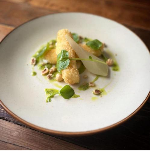 a white plate with a piece of food on a table at Royal Oak Hotel in Rosthwaite