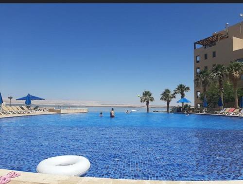 a large swimming pool with a frisbee in the water at Samarah Resort D27 Families only in Sowayma