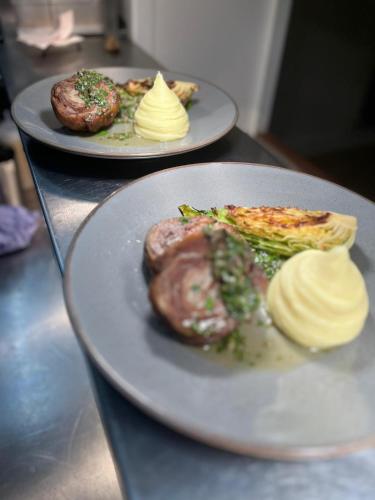 two plates of food on a table with pastries at Royal Oak Hotel in Rosthwaite