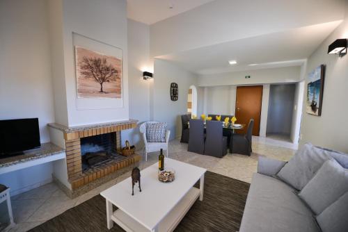 a living room with a couch and a fireplace at Regalo Apartments in Lygia