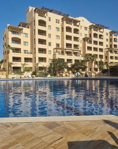 a large swimming pool in front of some buildings at Samarah Resort D27 Families only in Sowayma