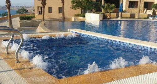 a large swimming pool with water in it at Samarah Resort D27 Families only in Sowayma