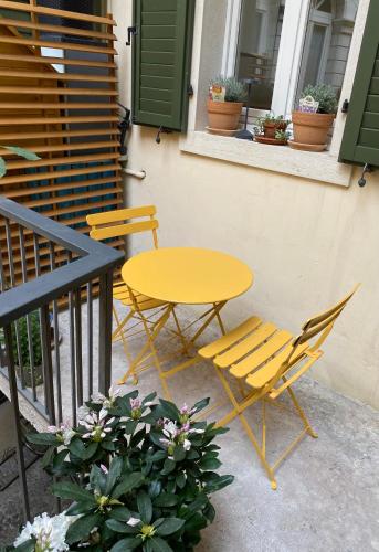 a yellow table and two chairs on a patio at Rebassotto in Rovereto