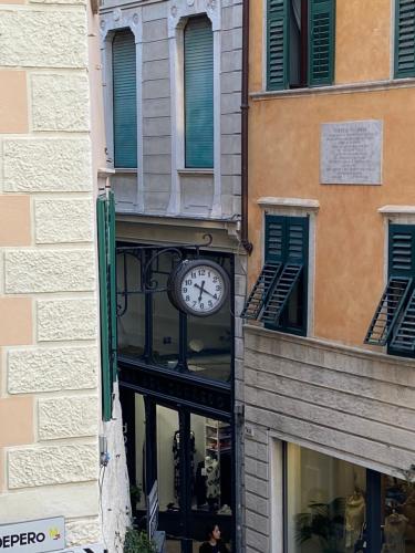 a clock on the side of a building at Rebassotto in Rovereto