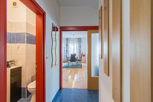 a bathroom with a toilet and a hallway at Flexible SelfCheckIns 47 - Zagreb - Two Loggia - New - 3 Bedrooms - 2 WC in Zagreb