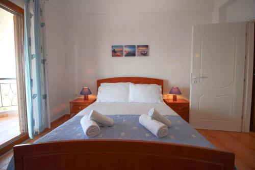 a bedroom with a bed with three pillows on it at Rooms to let Spiropali in Piqeras